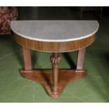 A demi-lune table with white marble top