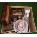 A box containing framed prints and pottery items