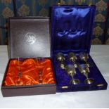 A box of five silver plated goblets together with a box of two Webb champagne flutes