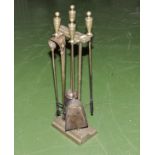 A brass fireside companion set