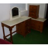 A pine dressing table, chest of three drawers and bedside drawers