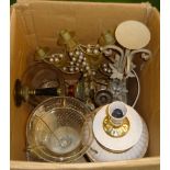 A box containing table lamps and candlesticks