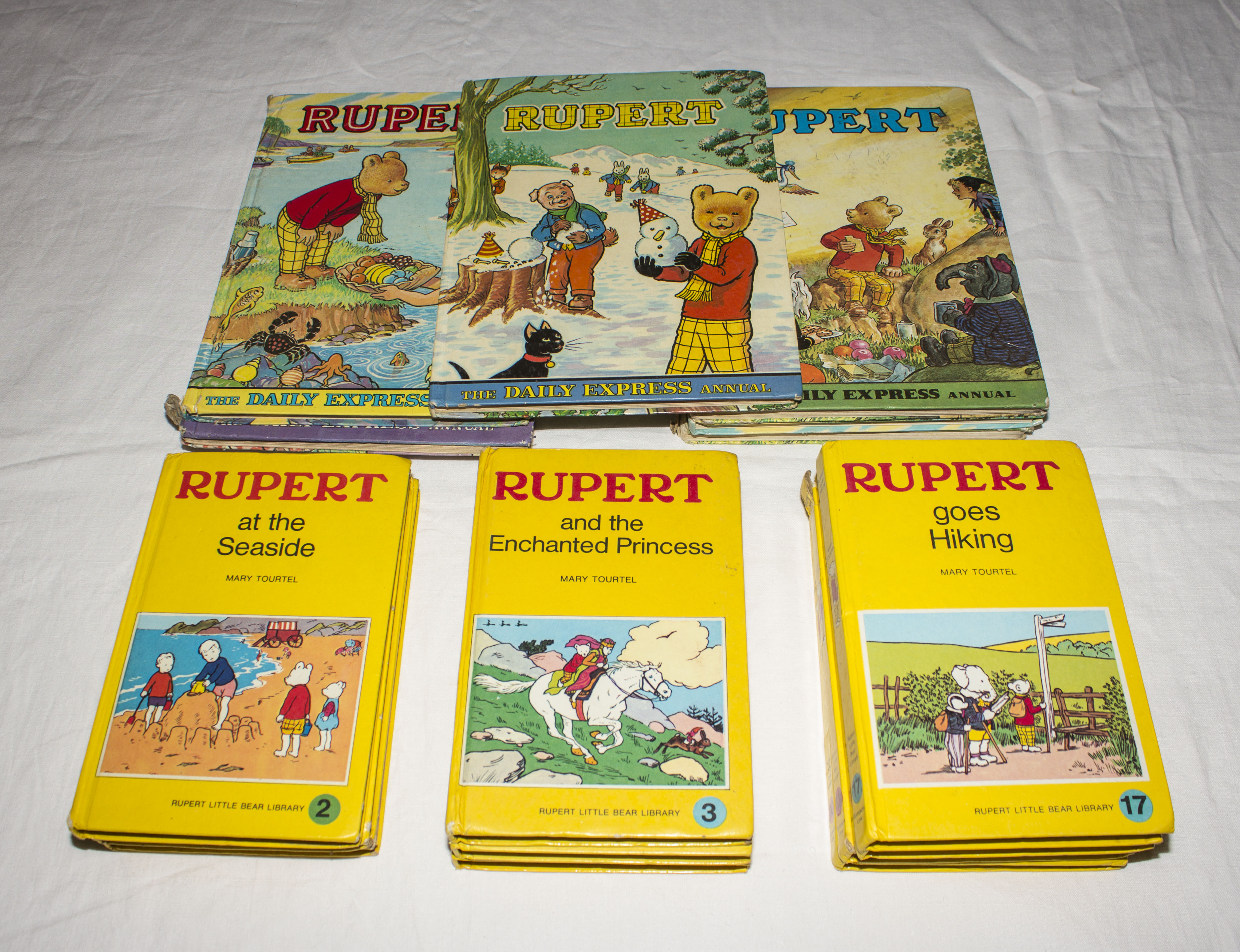 A collection of Rupert annuals and books