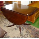 A drop leaf mahogany table