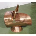 A copper coal scuttle