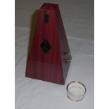 A metronome together with a silver napkin ring