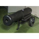 A vintage wooden model cannon on metal stand, 88cm in length