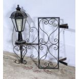 A wrought iron out door hanging corner lamp