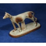 A pottery figure of a greyhound