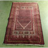 A hand woven wool Balochi rug, 85cm x 139cm