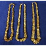 Three necklaces with amber coloured beads