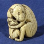 An ivory netsuke modelled as a monkey and baby