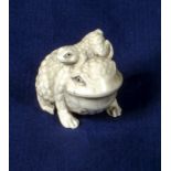 An ivory netsuke of a frog with young, signed