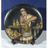 Cairo Ware 1920/30's dish depicting an Arab potter, 29cm diameter