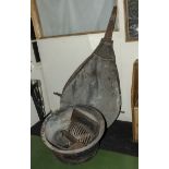 A large blacksmiths bellows together with a large cast iron cauldron and contents
