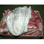 A box containing eiderdowns, wedding dress etc