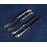 Four silver butter knives