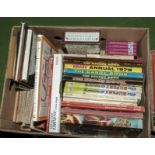 A box containing annuals and other books