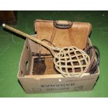 A box containing hand bags and a carpet beater