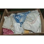 A box containing linen and fabrics