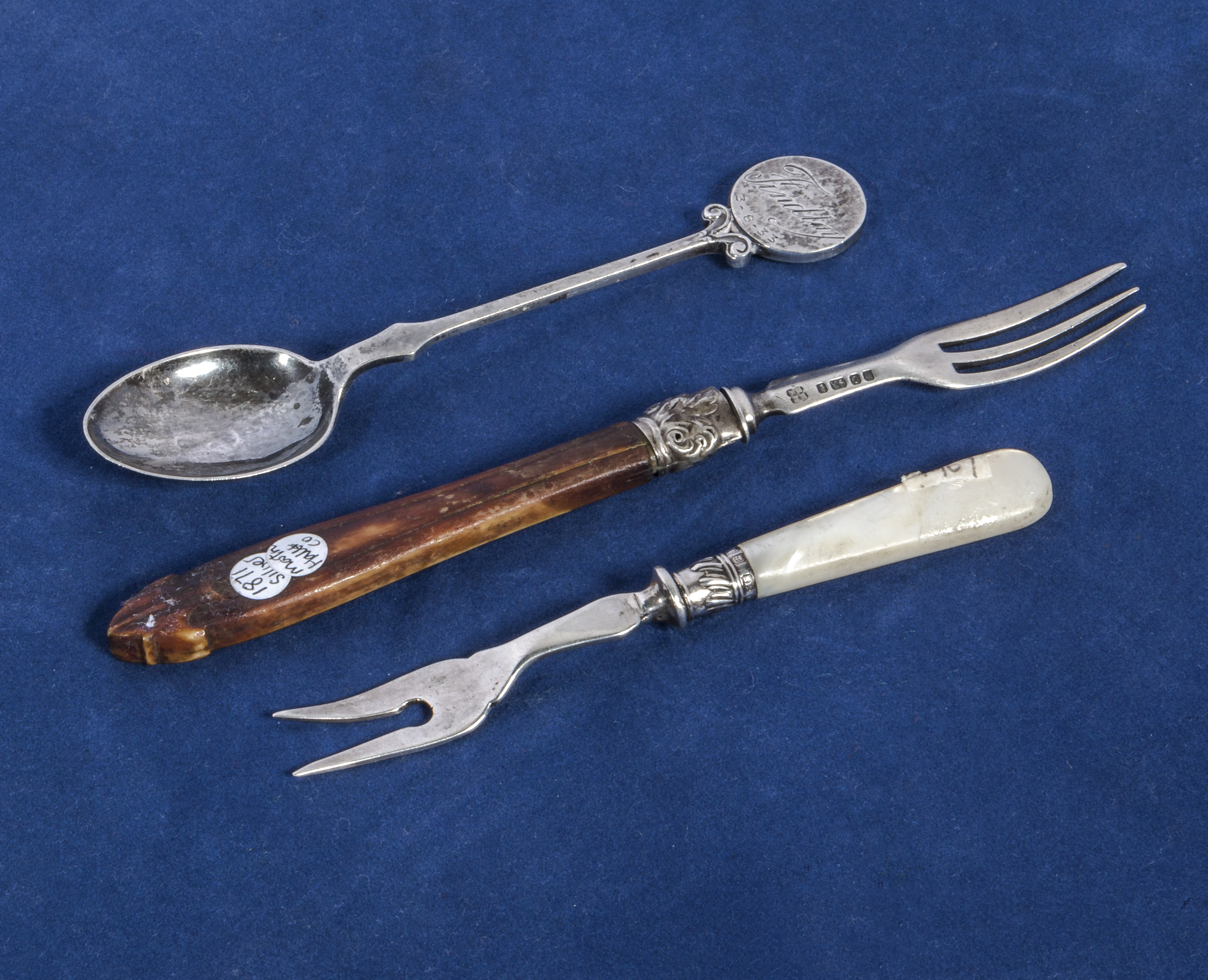 A silver pickle fork, fruit fork and a spoon