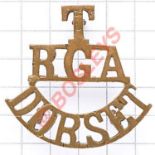 T / RGA / DORSET brass Royal Garrison Artillery shoulder title circa 1908-20. Loops Defended Port