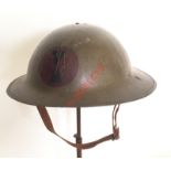 WW1 Brodie steel helmet. A fine B pattern example with green painted finish with painted US 7th