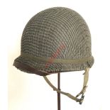 WWII Period US Army combat helmet. A scarce unissued example of the regulation pattern complete with