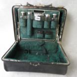 A Victorian leather travel case, fitted with silver mounted toilet bottles, dated London 1888