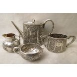 A 19th century Chinese silver matched tea set comprising tea, sugar and milk with another cream jug,