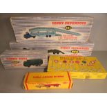 A Dinky Dublo flat truck, Army truck, tank transporter, road signs and a Pullmore transporter, all