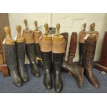 A selection of early 20th century leather riding boots, some with treen lasts