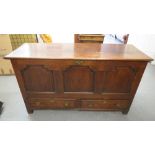 An early 18th century oak panel mule chest over drawers on block feet