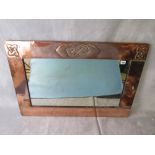 A Scottish arts and crafts copper wall mirror having Celtic knot and studwork decoration on a