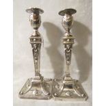 A pair of Victorian Hawksworth, Eyre & Co silver filled candlesticks in the neo classical revival