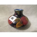 A small squat Moorcroft vase decorated in the Pomegranate pattern