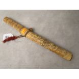 An early 20th century Asian dagger in a carved ivory sheath and with a carved ivory handle,