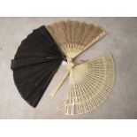 A French 19th century carved ivory fan with silk tassel and cardboard box A/F, a late 19th/early