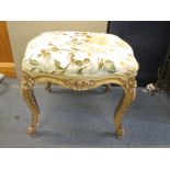 A 19th century French gilt wood stool having overstuffed seat on cabriole legs