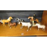 A group of Beswick horses to include a cross country rider and horse jumping over a fence