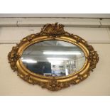 A gilt 19th century French oval wall mirror, 30 x 40 1/2