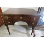 Georgian mahogany low boy, central drawer flanked by four short drawers, standing on ring turned