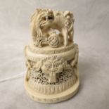 19th century Chinese carved ivory Koro lid, surmounted by two dogs of foe, above ringed masks and