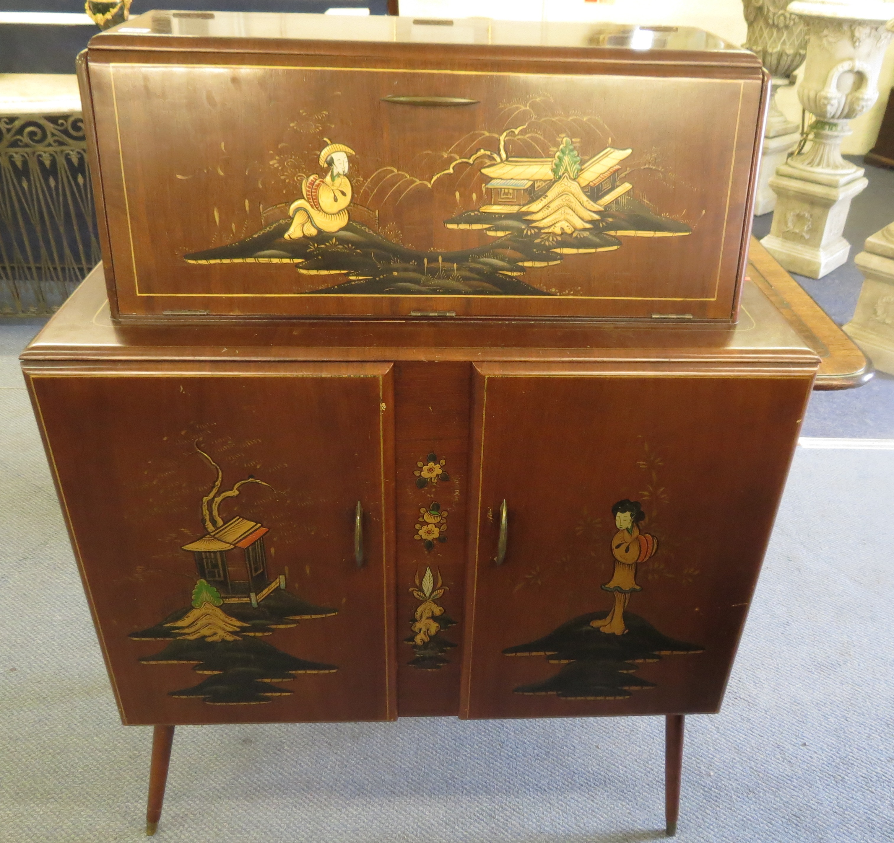 A 1950s retro japanned cocktail cabinet having a fitted interior on splayed legs