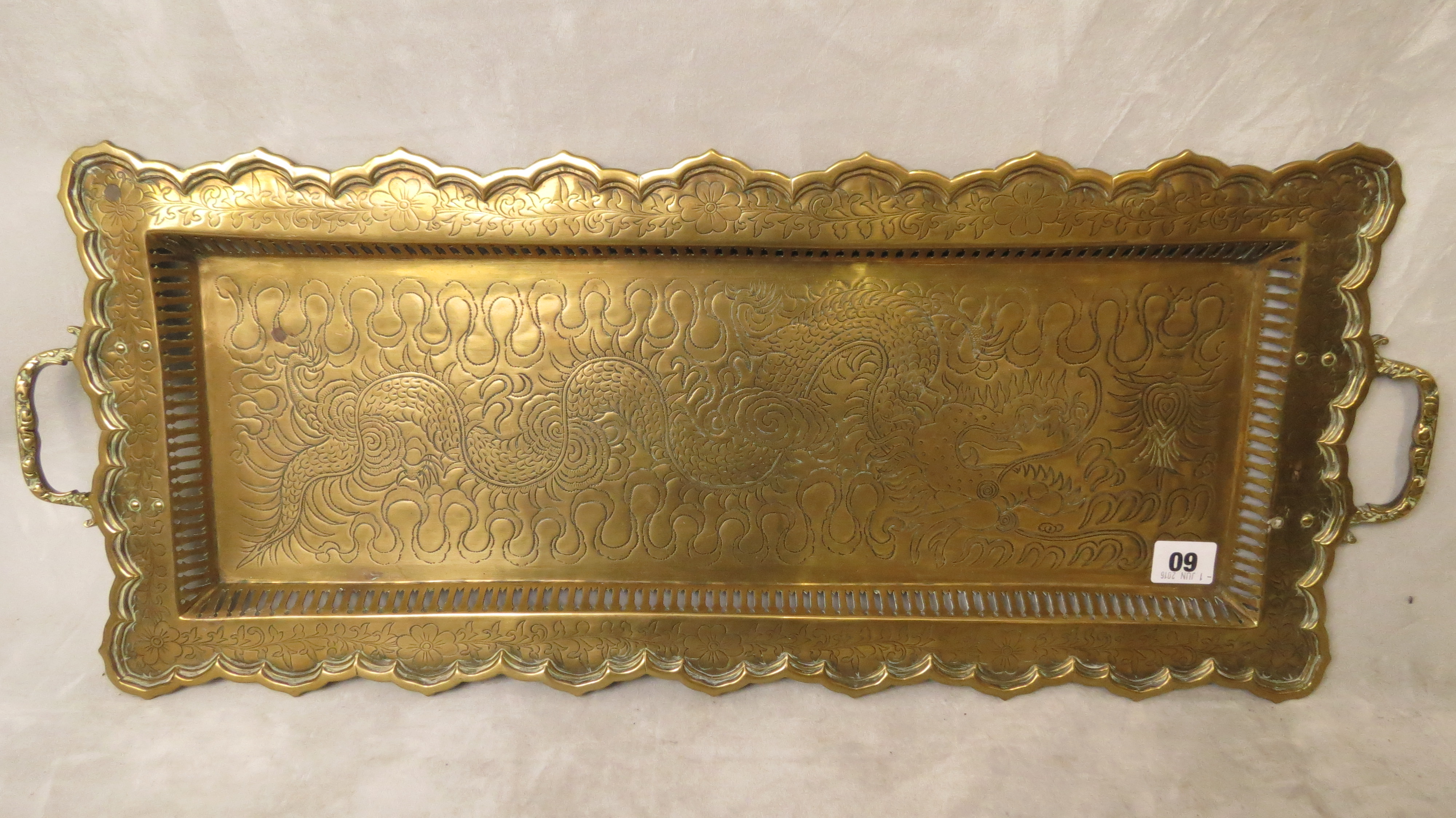 An early 20th century Chinese brass tray of rectangular form, engraved dragon decoration, twin