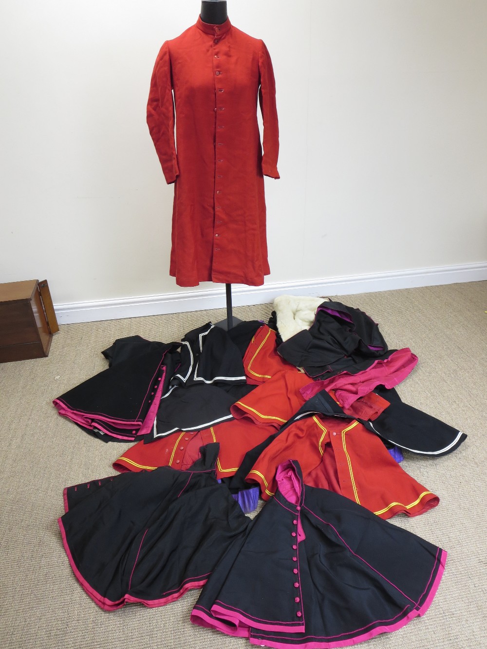 A large box containing a wide assortment of Catholic Church Dress including capes, one fur lined,