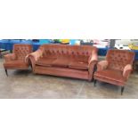 A pair of 19th Century button back Armchairs with claret plush upholstery on ebonised turned front