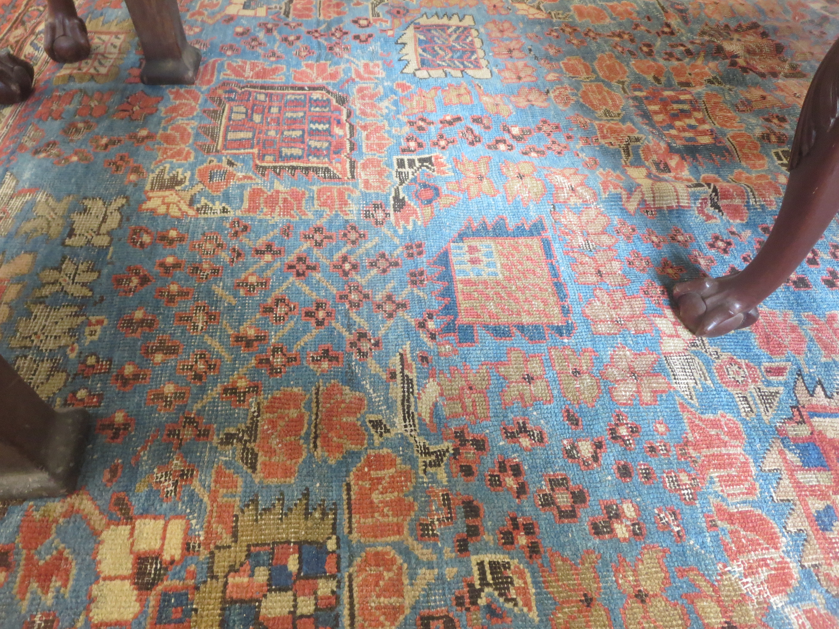 An old bordered Persian Carpet with red stylised motifs on a blue ground, principal border with - Image 8 of 8