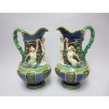 A pair of 19th Century Minton majolica Ewers moulded cherubs, ivy leaves, etc, 12in restored and A/