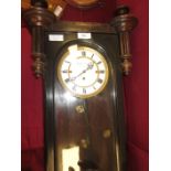 A 19th Century Vienna Wall Clock with white circular dial with triple brass cased weight driven